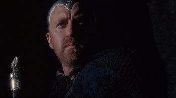 Movie still from “Excalibur” (1981), directed by John Boorman – A person with a beard; Close Up shot, Low angle