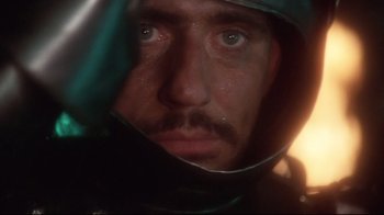 Movie still from “Excalibur” (1981), directed by John Boorman – A person wearing a hood; Close Up shot, Low angle