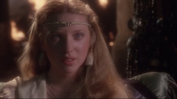 Movie still from “Excalibur” (1981), directed by John Boorman – A person with long blonde hair; Close Up shot, Over the shoulder angle