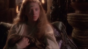 Movie still from “Excalibur” (1981), directed by John Boorman – A woman with long red hair wearing a white dress; Close Up shot, Over the shoulder angle