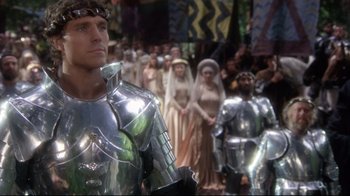 Movie still from “Excalibur” (1981), directed by John Boorman – A group of people dressed in medieval costumes; Medium shot, Low angle