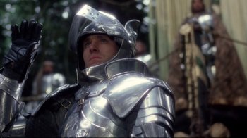 Movie still from “Excalibur” (1981), directed by John Boorman – A man in a suit of a medieval knight; Close Up shot, Low angle
