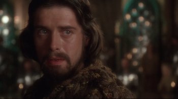 Movie still from “Excalibur” (1981), directed by John Boorman – A person wearing a fur coat; Close Up shot, Over the shoulder angle