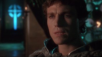 Movie still from “Excalibur” (1981), directed by John Boorman – A person wearing a jacket; Close Up shot, Over the shoulder angle