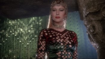 Movie still from “Excalibur” (1981), directed by John Boorman – A woman wearing a dress and a headpiece; Close Up shot, Low angle