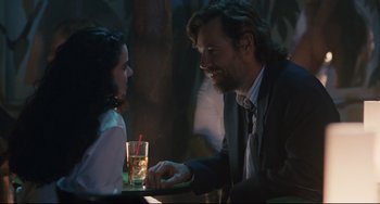 Movie still from “Exotica” (1994), directed by Atom Egoyan – A man and a woman sitting at a table; Medium shot, Over the shoulder angle