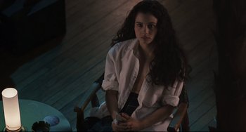 Movie still from “Exotica” (1994), directed by Atom Egoyan – A woman sitting in a chair holding a cell phone; Medium shot, High angle