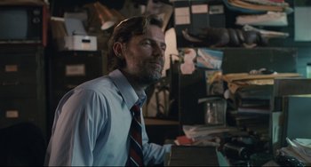 Movie still from “Exotica” (1994), directed by Atom Egoyan – A man wearing a blue dress shirt and a red tie; Close Up shot, Over the shoulder angle