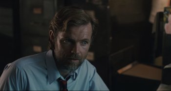 Movie still from “Exotica” (1994), directed by Atom Egoyan – A person wearing a shirt and a tie; Close Up shot, Over the shoulder angle