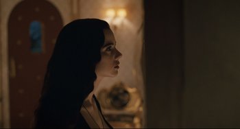 Movie still from “Exotica” (1994), directed by Atom Egoyan – A beautiful woman standing next to a wall; Close Up shot, Over the shoulder angle