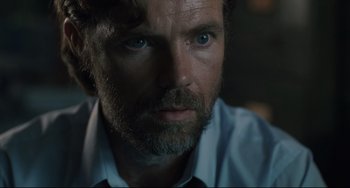 Movie still from “Exotica” (1994), directed by Atom Egoyan – A person wearing a shirt and tie; Close Up shot, Over the shoulder angle