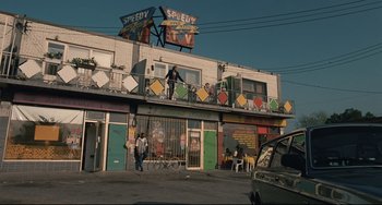 Movie still from “Exotica” (1994), directed by Atom Egoyan – People are standing on the balcony of a building; Extreme Wide shot, Low angle