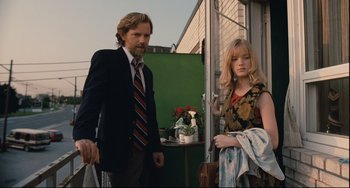 Movie still from “Exotica” (1994), directed by Atom Egoyan – A man and a woman standing next to each other; Medium shot, Low angle