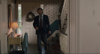Movie still from “Exotica” (1994), directed by Atom Egoyan – A man in a suit walking down the hall way; Medium shot, Over the shoulder angle