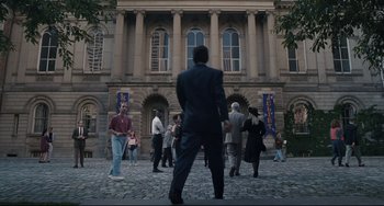 Movie still from “Exotica” (1994), directed by Atom Egoyan – A group of people standing in front of a building; Extreme Wide shot, High angle