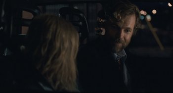 Movie still from “Exotica” (1994), directed by Atom Egoyan – A man in a suit and tie talking to a woman in a car; Close Up shot, Over the shoulder angle