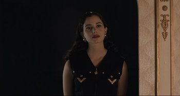 Movie still from “Exotica” (1994), directed by Atom Egoyan – A woman in a black vest standing in front of a mirror; Close Up shot, Low angle