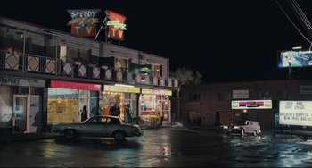 Movie still from “Exotica” (1994), directed by Atom Egoyan – A car parked in front of a building at night; Extreme Wide shot, High angle