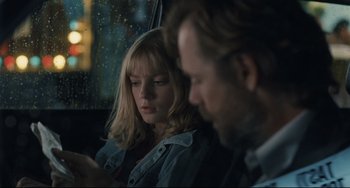 Movie still from “Exotica” (1994), directed by Atom Egoyan – A man and a woman sitting next to each other in a car; Close Up shot, Over the shoulder angle