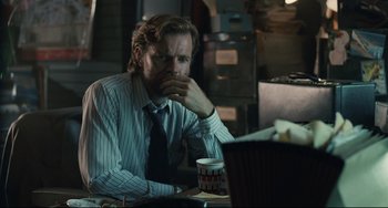 Movie still from “Exotica” (1994), directed by Atom Egoyan – A man sitting in front of a laptop computer; Close Up shot, Over the shoulder angle