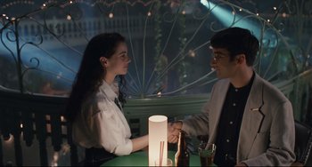 Movie still from “Exotica” (1994), directed by Atom Egoyan – A man and a woman shaking hands over a table; Medium shot, Over the shoulder angle