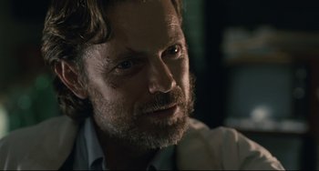 Movie still from “Exotica” (1994), directed by Atom Egoyan – A person with a beard; Close Up shot, Over the shoulder angle