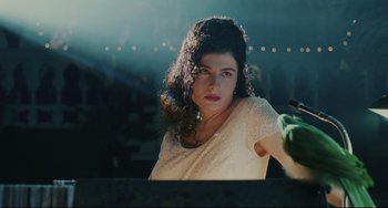 Movie still from “Exotica” (1994), directed by Atom Egoyan – A beautiful woman with curly hair wearing a white dress; Close Up shot, Over the shoulder angle