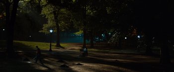 Movie still from “Extremely Loud & Incredibly Close” (2011), directed by Stephen Daldry – A person sitting on a bench in a park at night; Extreme Wide shot, High angle