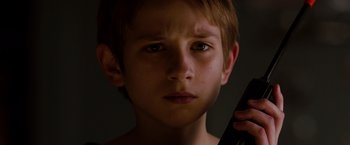 Movie still from “Extremely Loud & Incredibly Close” (2011), directed by Stephen Daldry – A young boy holding a cell phone up to his ear; Close Up shot, Low angle