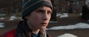 Movie still from “Extremely Loud & Incredibly Close” (2011), directed by Stephen Daldry – A young boy wearing a winter hat and scarf; Close Up shot, High angle