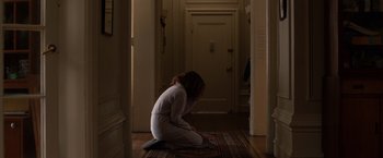 Movie still from “Extremely Loud & Incredibly Close” (2011), directed by Stephen Daldry – A woman kneeling on the ground in a room; Wide shot, High angle