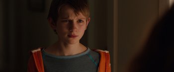 Movie still from “Extremely Loud & Incredibly Close” (2011), directed by Stephen Daldry – A young boy is looking at the camera; Close Up shot, Over the shoulder angle