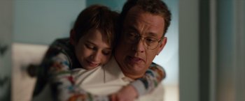 Movie still from “Extremely Loud & Incredibly Close” (2011), directed by Stephen Daldry – A man and a boy are hugging each other; Close Up shot, Over the shoulder angle