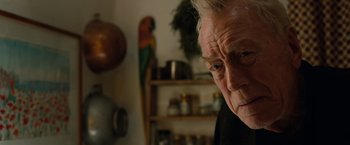 Movie still from “Extremely Loud & Incredibly Close” (2011), directed by Stephen Daldry – An older man looking at the camera in a kitchen; Close Up shot, Over the shoulder angle