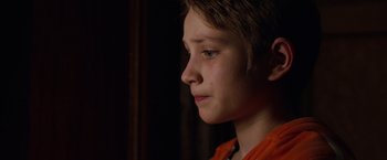 Movie still from “Extremely Loud & Incredibly Close” (2011), directed by Stephen Daldry – A young boy is looking to his left; Close Up shot, Over the shoulder angle