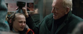Movie still from “Extremely Loud & Incredibly Close” (2011), directed by Stephen Daldry – An older man brushing a younger man's hair on a train; Close Up shot, Over the shoulder angle