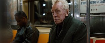 Movie still from “Extremely Loud & Incredibly Close” (2011), directed by Stephen Daldry – An older man sitting on a bus looking sad; Close Up shot, High angle