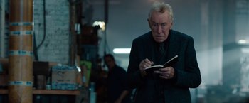 Movie still from “Extremely Loud & Incredibly Close” (2011), directed by Stephen Daldry – An older man reading a book in a room; Close Up shot, Over the shoulder angle