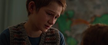 Movie still from “Extremely Loud & Incredibly Close” (2011), directed by Stephen Daldry – A young boy with a sweater on is crying; Close Up shot, Over the shoulder angle