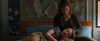 Movie still from “Extremely Loud & Incredibly Close” (2011), directed by Stephen Daldry – A young girl laying in bed next to an older woman; Medium shot, Over the shoulder angle