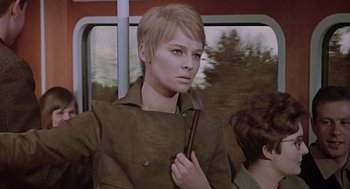Movie still from “Fahrenheit 451” (1966), directed by François Truffaut – A woman in a trench coat on a train; Medium shot, Low angle