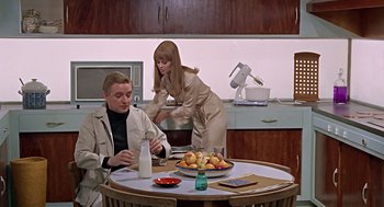 Movie still from “Fahrenheit 451” (1966), directed by François Truffaut – A man and a woman are sitting at a table; Medium shot, High angle