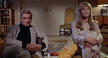 Movie still from “Fahrenheit 451” (1966), directed by François Truffaut – A man and a woman sitting in a living room; Medium shot, Low angle