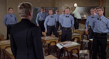 Movie still from “Fahrenheit 451” (1966), directed by François Truffaut – A group of young men standing in front of each other; Wide shot, High angle