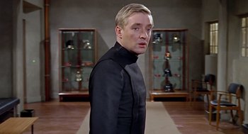 Movie still from “Fahrenheit 451” (1966), directed by François Truffaut – A man in a black suit standing in a room; Close Up shot, Low angle