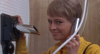 Movie still from “Fahrenheit 451” (1966), directed by François Truffaut – A woman holding a phone up to her ear; Close Up shot, Low angle