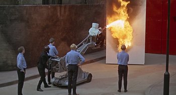Movie still from “Fahrenheit 451” (1966), directed by François Truffaut – A group of people standing around a fire; Extreme Wide shot, High angle