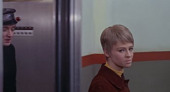 Movie still from “Fahrenheit 451” (1966), directed by François Truffaut – A woman with short blonde hair wearing a brown jacket; Close Up shot, Low angle
