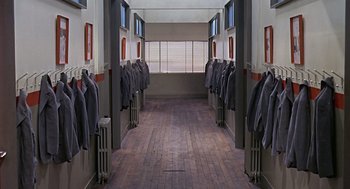 Movie still from “Fahrenheit 451” (1966), directed by François Truffaut – A long hallway with a row of jackets hanging on the wall; Wide shot, Overhead angle