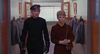 Movie still from “Fahrenheit 451” (1966), directed by François Truffaut – A man and a woman are standing in a room; Medium shot, Low angle